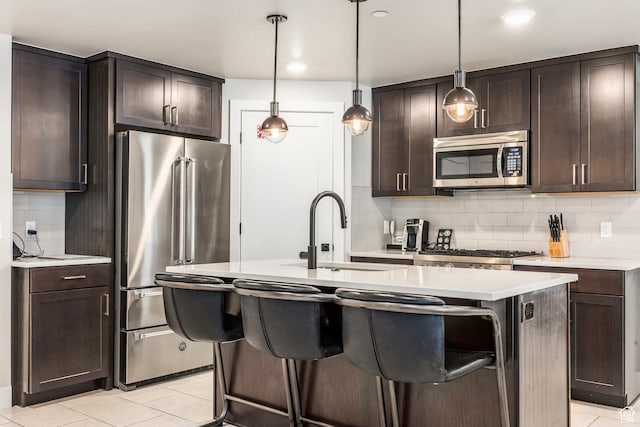 909 W Peace Tree Trl Unit 206, Kamas, UT 84036 - kitchen with light countertops, dark brown cabinets, tasteful backsplash, and appliances with stainless steel finishes