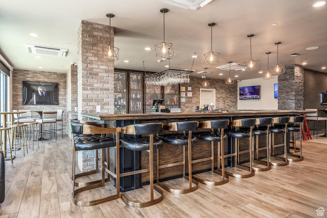 909 W Peace Tree Trl Unit 206, Kamas, UT 84036 - bar featuring recessed lighting, brick wall, visible vents, a community bar, and wood finished floors