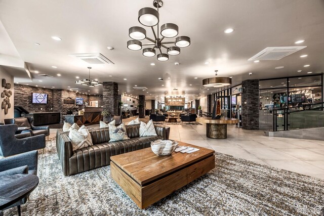 909 W Peace Tree Trl Unit 206, Kamas, UT 84036 - tiled living area featuring visible vents, an inviting chandelier, recessed lighting, and ornate columns