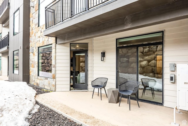 909 W Peace Tree Trl Unit 206, Kamas, UT 84036 - view of exterior entry featuring a balcony, a patio area, and stone siding