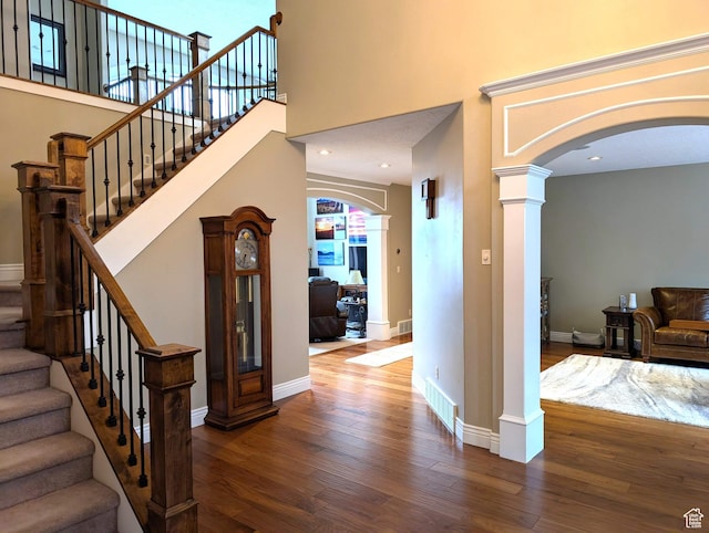 2524 E 700 S, Springville, UT 84663 - entryway with baseboards, wood finished floors, decorative columns, arched walkways, and a high ceiling