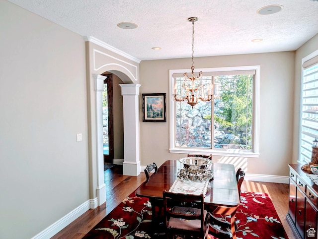 2524 E 700 S, Springville, UT 84663 - dining space with arched walkways, wood finished floors, an inviting chandelier, and decorative columns