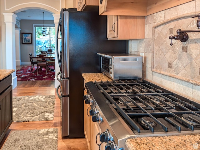 2524 E 700 S, Springville, UT 84663 - kitchen with a toaster, stainless steel range with gas stovetop, light brown cabinetry, and light wood-style floors