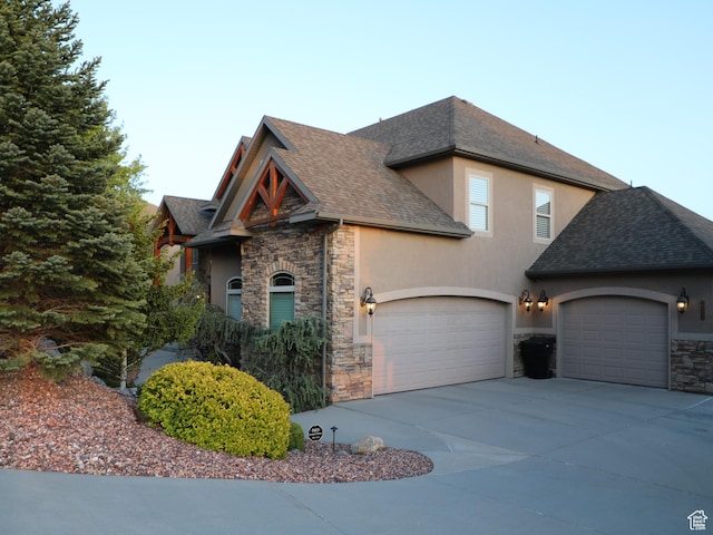 2524 E 700 S, Springville, UT 84663 - view of front of home featuring stone siding, driveway, a garage, stucco siding, and a shingled roof