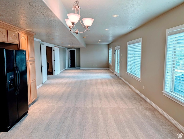 2524 E 700 S, Springville, UT 84663 - interior space featuring light carpet, baseboards, a textured ceiling, and a chandelier