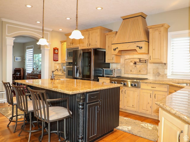 2524 E 700 S, Springville, UT 84663 - kitchen featuring arched walkways, custom exhaust hood, light brown cabinetry, and stainless steel appliances