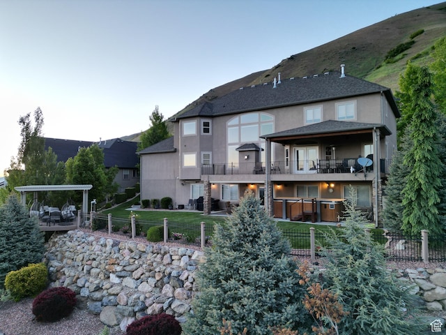 2524 E 700 S, Springville, UT 84663 - rear view of property featuring a yard, a balcony, stucco siding, and fence