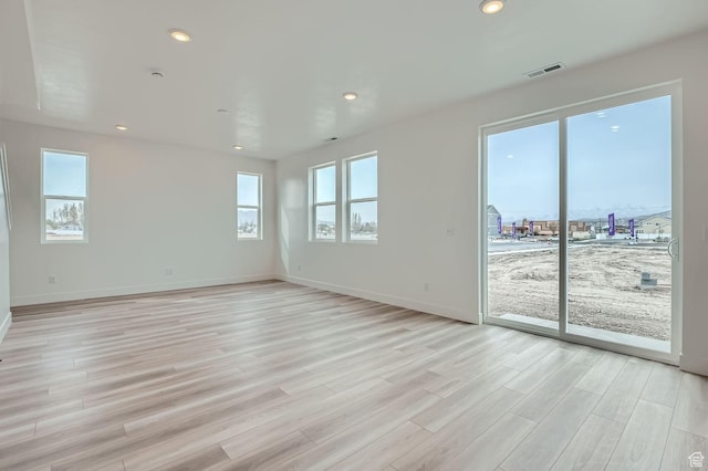 unfurnished room featuring recessed lighting, visible vents, and light wood-style flooring