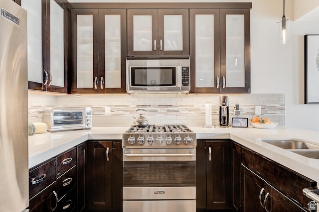3676 Blackstone Dr, Park City, UT 84098 - kitchen featuring tasteful backsplash, light countertops, appliances with stainless steel finishes, and dark brown cabinets