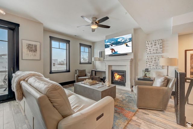 3676 Blackstone Dr, Park City, UT 84098 - living room with a glass covered fireplace, light wood-style floors, and ceiling fan