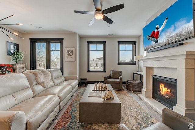 3676 Blackstone Dr, Park City, UT 84098 - living area featuring wood finished floors, visible vents, a glass covered fireplace, and ceiling fan