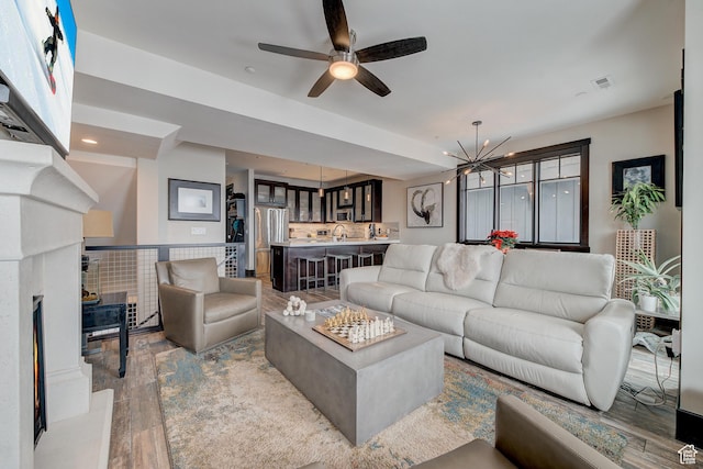 3676 Blackstone Dr, Park City, UT 84098 - living room featuring light wood finished floors, ceiling fan with notable chandelier, visible vents, and recessed lighting