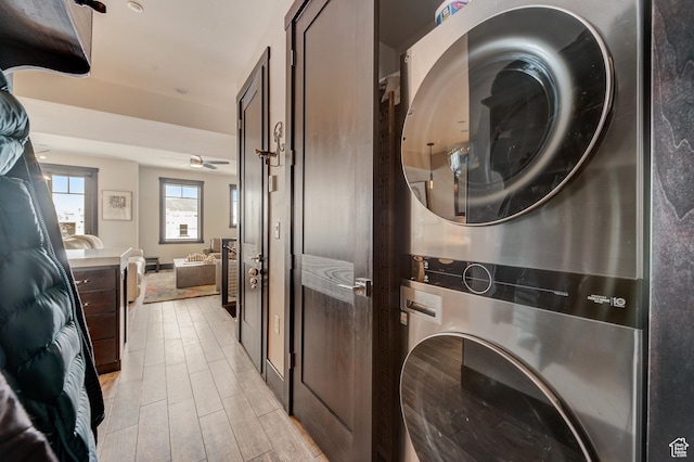 3676 Blackstone Dr, Park City, UT 84098 - laundry room featuring stacked washer and clothes dryer, wood tiled floor, and laundry area