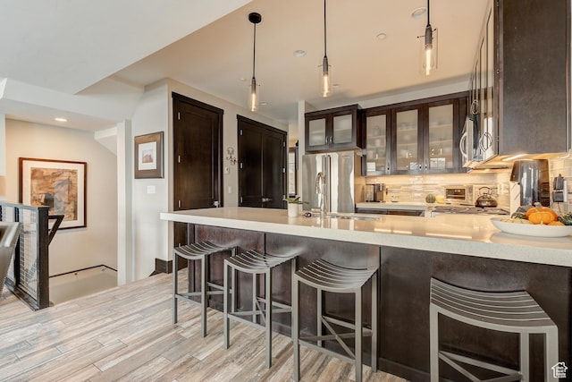 3676 Blackstone Dr, Park City, UT 84098 - kitchen featuring light countertops, dark brown cabinets, and decorative backsplash