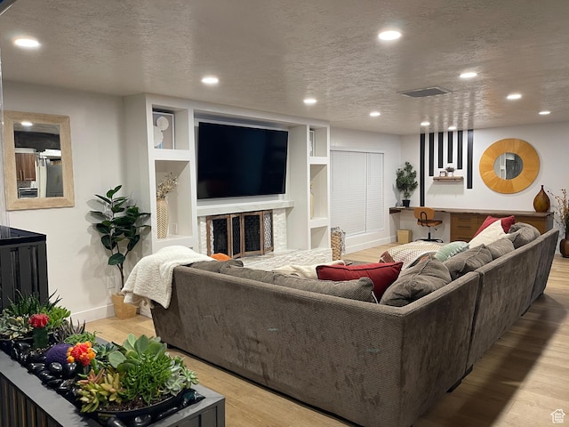 3444 S 1100 E, Millcreek, UT 84106 - living room with recessed lighting, light wood finished floors, and a textured ceiling