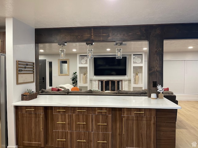 3444 S 1100 E, Millcreek, UT 84106 - kitchen with a textured ceiling, light wood-style flooring, modern cabinets, light stone countertops, and open floor plan