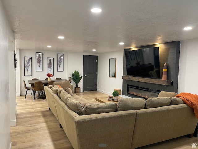 3444 S 1100 E, Millcreek, UT 84106 - living area with light wood finished floors, baseboards, recessed lighting, and a textured ceiling