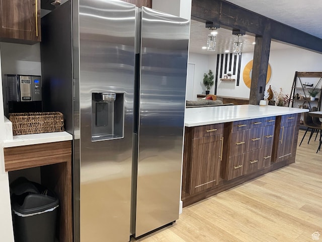 3444 S 1100 E, Millcreek, UT 84106 - kitchen with light wood finished floors, light countertops, dark brown cabinets, and stainless steel refrigerator with ice dispenser