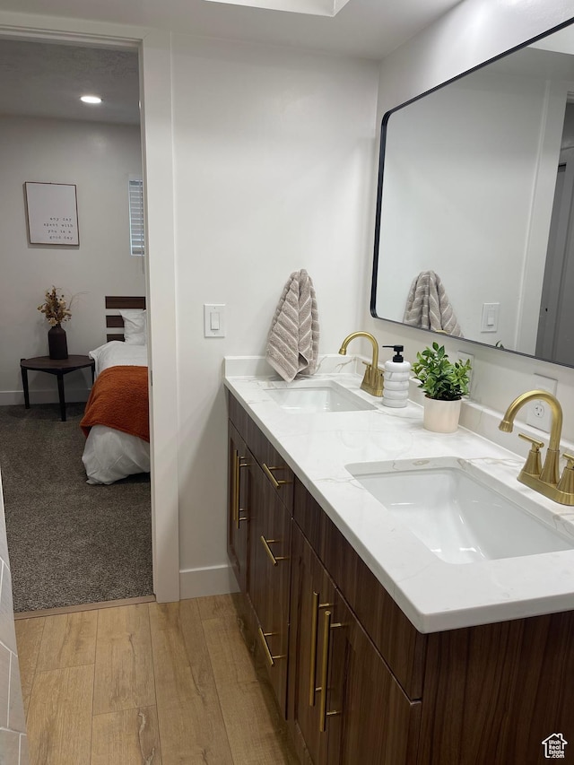 3444 S 1100 E, Millcreek, UT 84106 - ensuite bathroom with connected bathroom, double vanity, wood finished floors, and a sink
