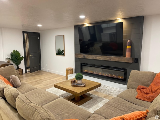 3444 S 1100 E, Millcreek, UT 84106 - living area featuring a fireplace, wood finished floors, recessed lighting, and a textured ceiling