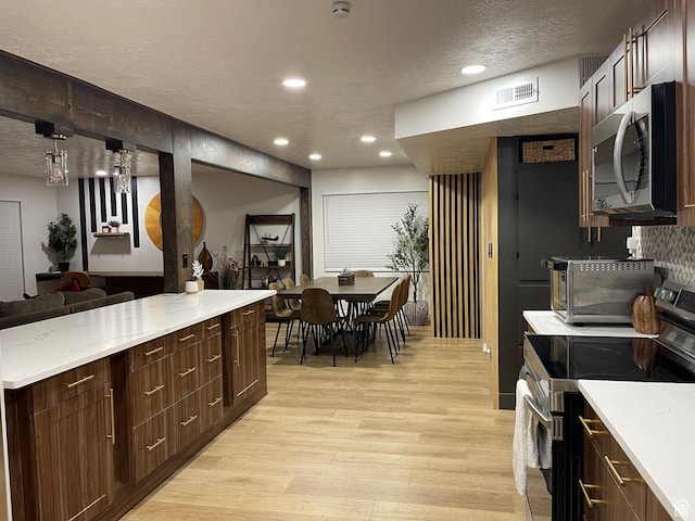 3444 S 1100 E, Millcreek, UT 84106 - kitchen with recessed lighting, stainless steel appliances, a textured ceiling, light wood finished floors, and visible vents