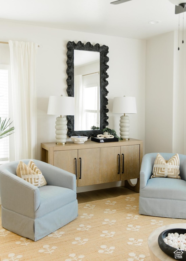 sitting room with plenty of natural light and wood finished floors