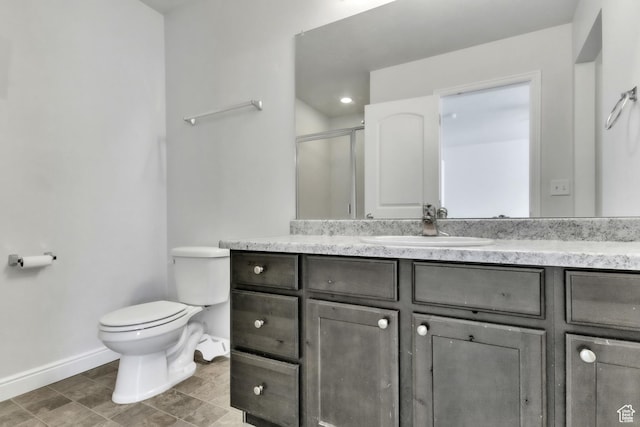 14292 S Autumn Path Ln W, Riverton, UT 84096 - bathroom featuring baseboards, a stall shower, toilet, and vanity