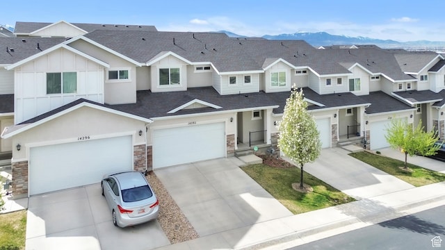 14292 S Autumn Path Ln W, Riverton, UT 84096 - townhome / multi-family property featuring roof with shingles, stucco siding, stone siding, and concrete driveway