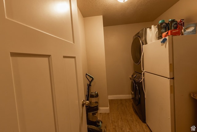 660 E 400 N, Spring City, UT 84662 - washroom featuring stacked washer / drying machine, baseboards, a textured ceiling, light wood-style floors, and laundry area
