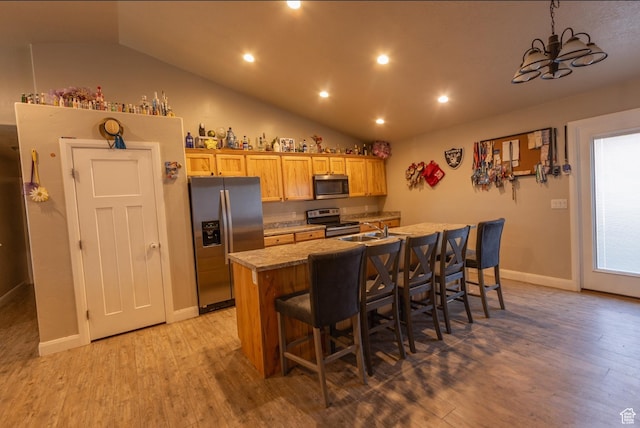 660 E 400 N, Spring City, UT 84662 - kitchen featuring an island with sink, a breakfast bar area, light wood-style flooring, and appliances with stainless steel finishes