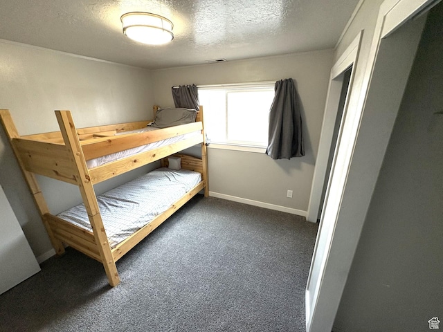 unfurnished bedroom featuring carpet flooring, visible vents, baseboards, and a textured ceiling