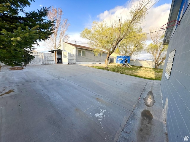view of front of house with a playground, fence, and a front lawn