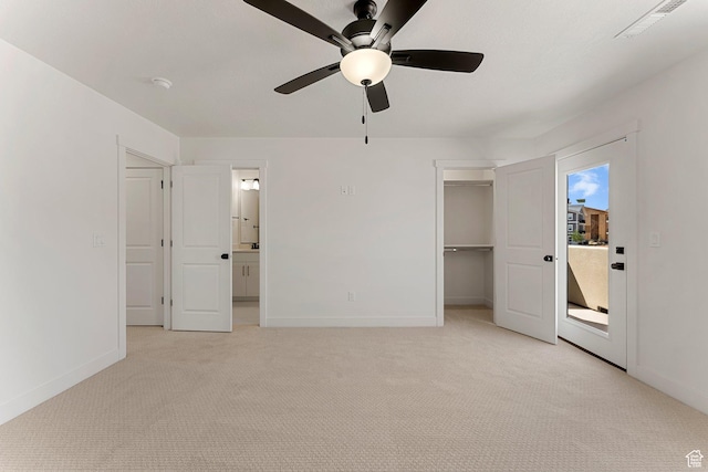 518 W Olive Ln, St George, UT 84790 - unfurnished bedroom featuring light carpet, a walk in closet, a ceiling fan, and ensuite bath