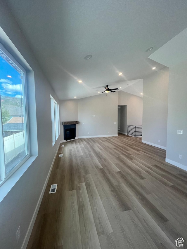 335 E 340 S, Kamas, UT 84036 - unfurnished living room with vaulted ceiling, baseboards, visible vents, a fireplace, and wood finished floors