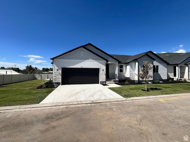 335 E 340 S, Kamas, UT 84036 - view of front of property featuring a front lawn, driveway, an attached garage, and fence