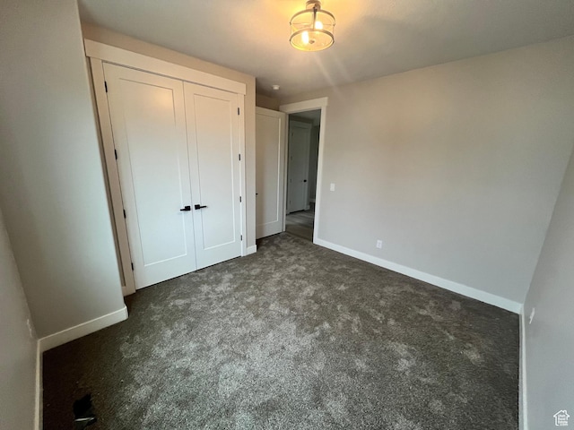 335 E 340 S, Kamas, UT 84036 - unfurnished bedroom featuring baseboards, a closet, and dark carpet