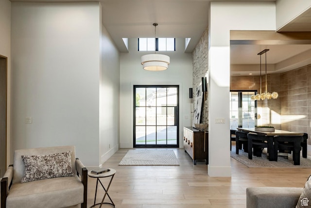 13926 S Jarvie Ln E, Draper, UT 84020 - entryway with light wood-type flooring, a high ceiling, a chandelier, and baseboards