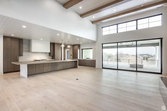 13926 S Jarvie Ln E, Draper, UT 84020 - kitchen featuring decorative backsplash, modern cabinets, light countertops, and light wood finished floors