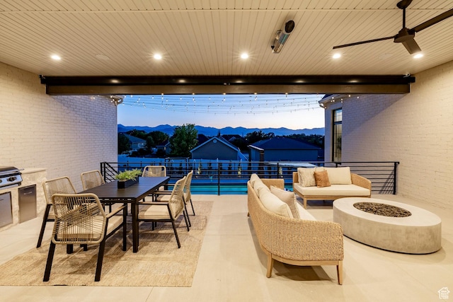 13926 S Jarvie Ln E, Draper, UT 84020 - view of patio / terrace featuring a mountain view, outdoor dining space, a ceiling fan, and an outdoor fire pit