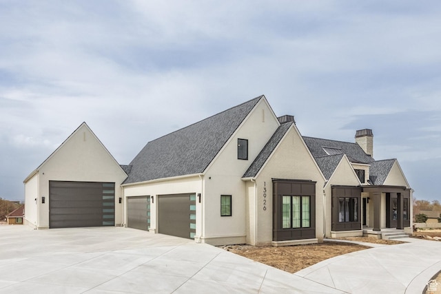 13926 S Jarvie Ln E, Draper, UT 84020 - view of front of house with a chimney, a shingled roof, a garage, and concrete driveway