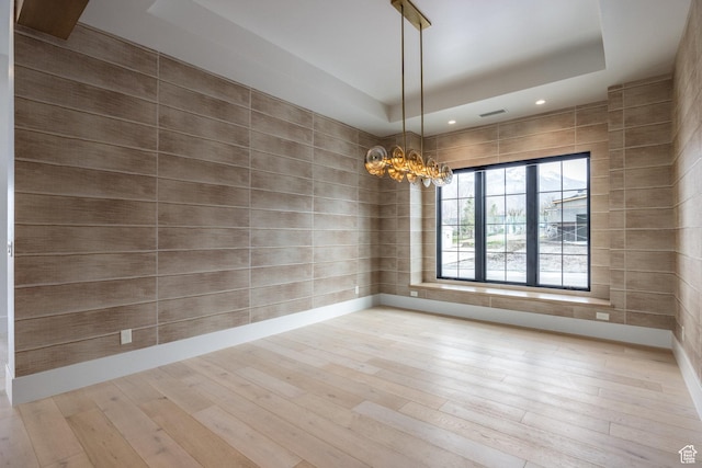 13926 S Jarvie Ln E, Draper, UT 84020 - unfurnished room with a tray ceiling, visible vents, wood finished floors, and a chandelier