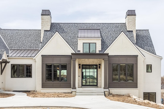 13926 S Jarvie Ln E, Draper, UT 84020 - exterior space featuring a chimney, a shingled roof, a standing seam roof, and brick siding