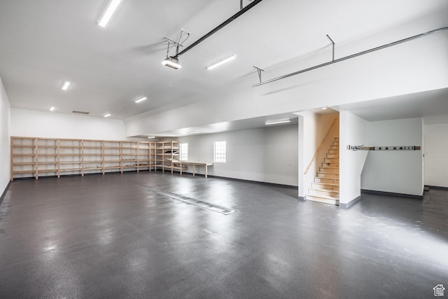 13926 S Jarvie Ln E, Draper, UT 84020 - garage featuring baseboards and a garage door opener