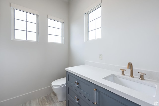 13926 S Jarvie Ln E, Draper, UT 84020 - bathroom featuring baseboards, toilet, vanity, and wood finished floors