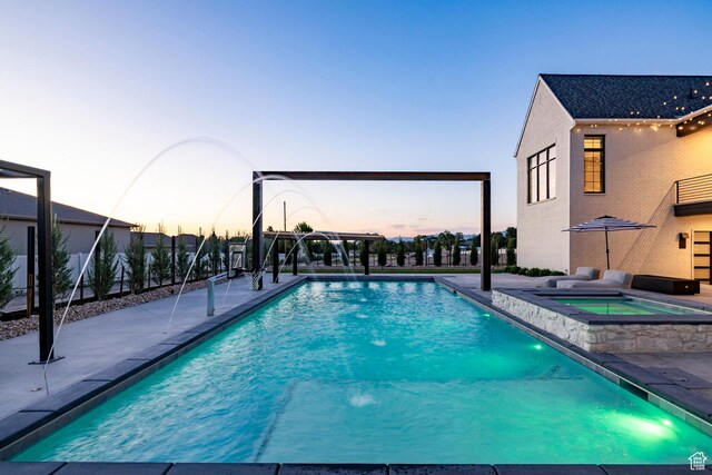13926 S Jarvie Ln E, Draper, UT 84020 - pool at dusk with an outdoor pool, an in-ground hot tub, and a patio area