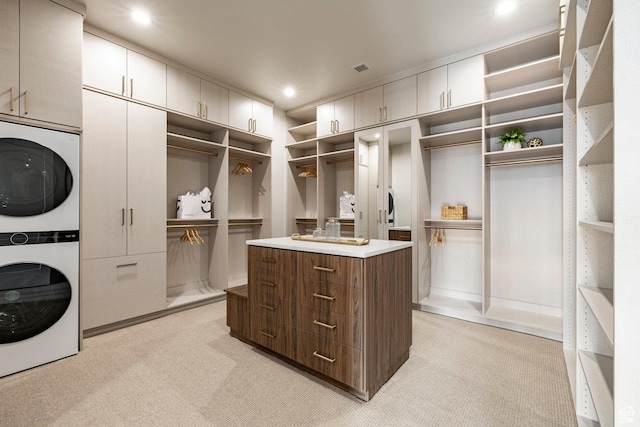 13926 S Jarvie Ln E, Draper, UT 84020 - walk in closet featuring stacked washer and clothes dryer and light carpet