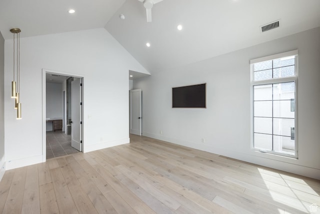 13926 S Jarvie Ln E, Draper, UT 84020 - unfurnished living room with light wood-type flooring, recessed lighting, high vaulted ceiling, baseboards, and visible vents