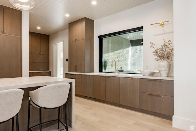 13926 S Jarvie Ln E, Draper, UT 84020 - kitchen featuring light wood-style flooring, light countertops, recessed lighting, and modern cabinets