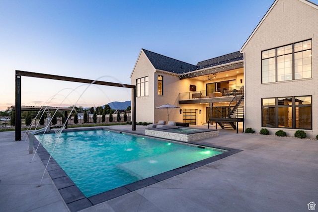 13926 S Jarvie Ln E, Draper, UT 84020 - pool at dusk with a patio area, stairway, and a pool with connected hot tub