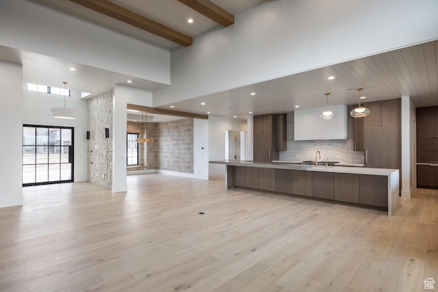13926 S Jarvie Ln E, Draper, UT 84020 - kitchen featuring open floor plan, light countertops, a towering ceiling, and modern cabinets